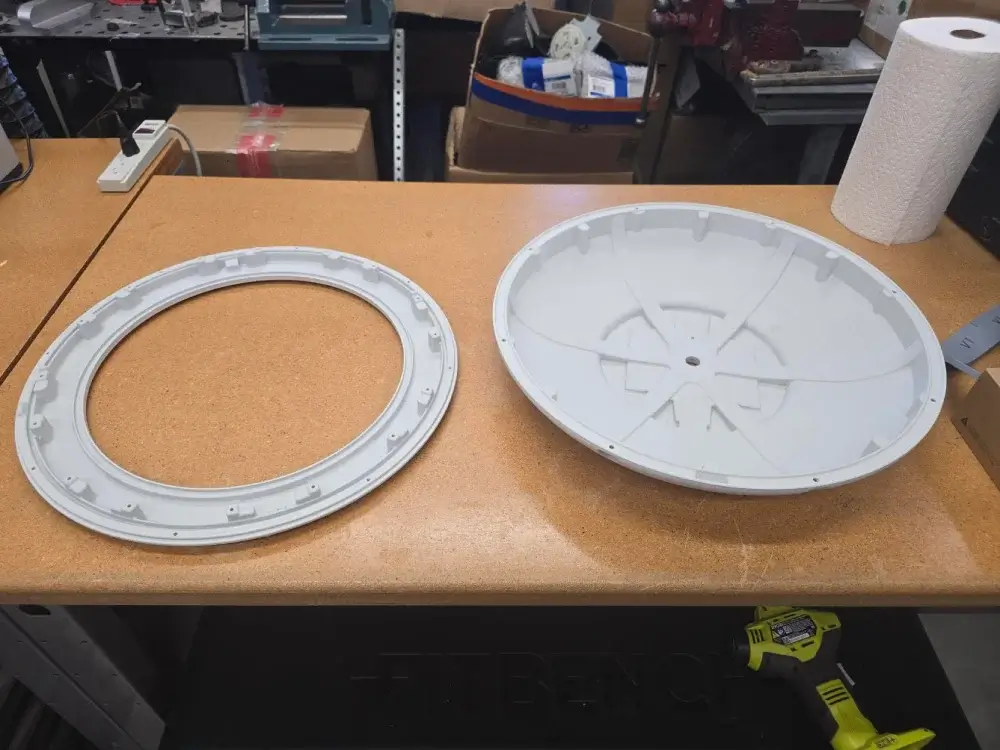 Bottom view of two 3D printed components for a LEP high-bay lighting fixture, demonstrating precision prototyping and mechanical design for industrial products.