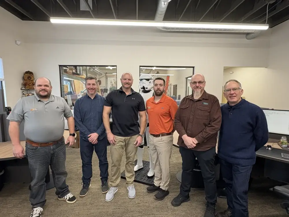 Concept-2-Solution-Mechanical-Design-Engineering-Team Concept 2 Solution mechanical design team standing in their engineering office and prototyping lab.
